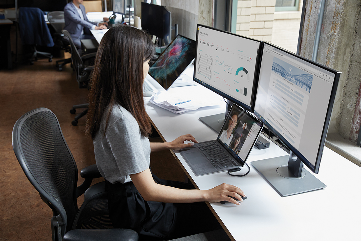 Woman at desk with computers