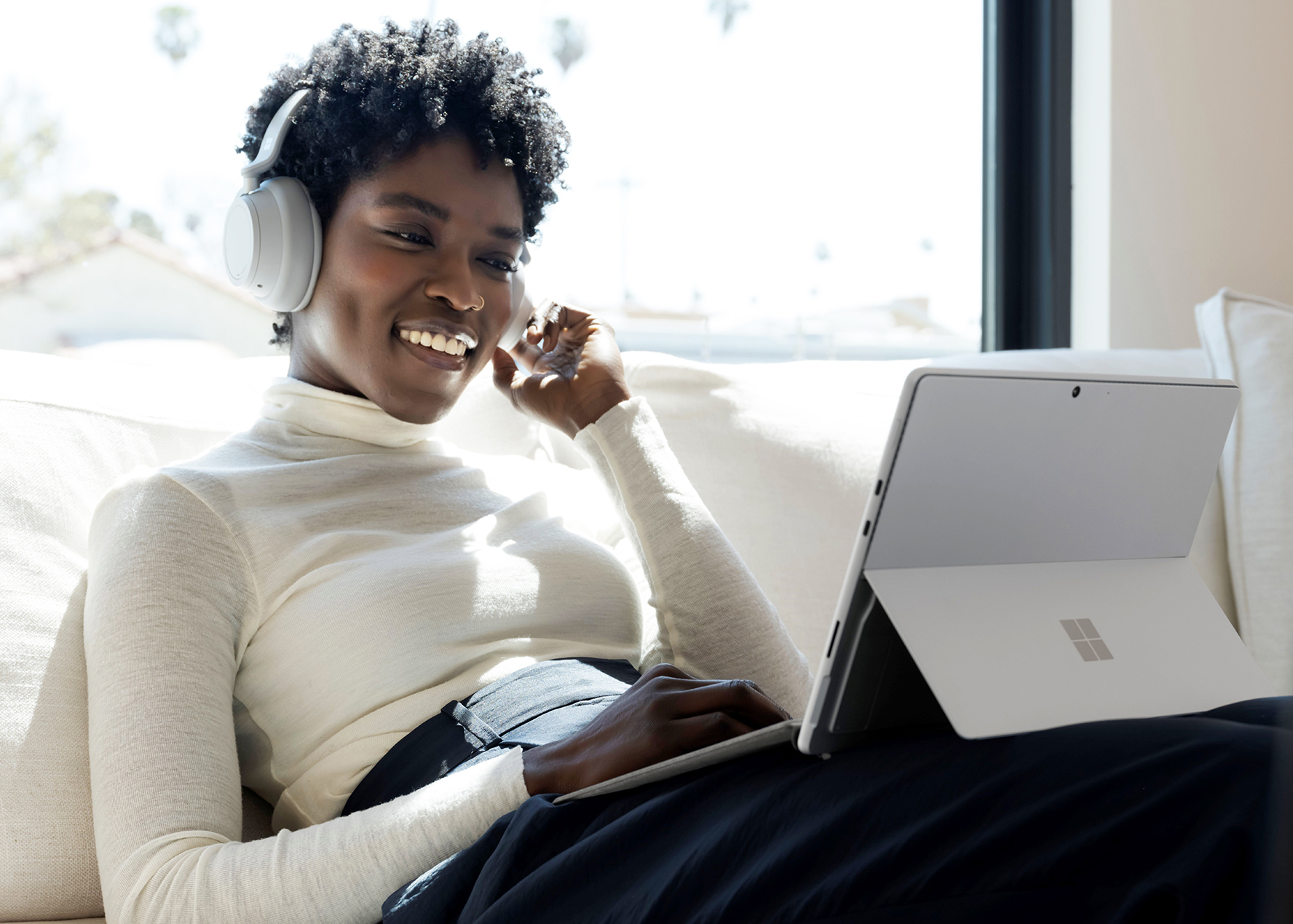 Woman on couch with computer