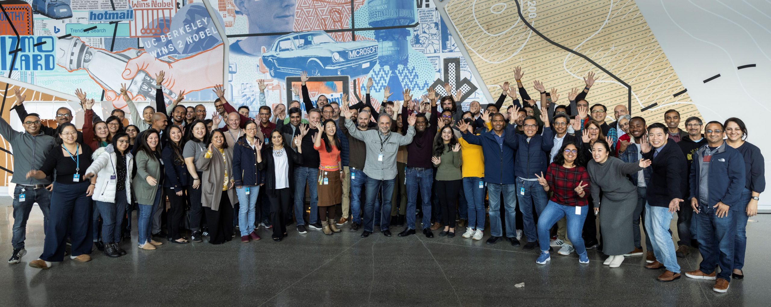 Members of the Azure Hardware Systems and Infrastructure organization raising their hands in the air.