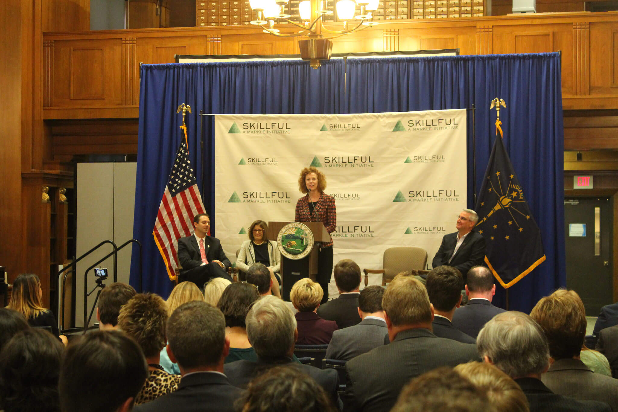 Mary Snapp on stage in front of a crowd speaking at the launch of Skillful Indiana