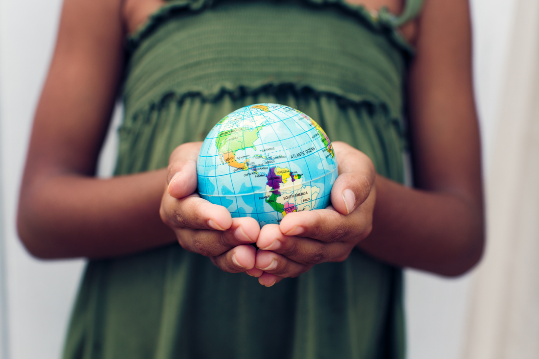 a globe being held by a young person