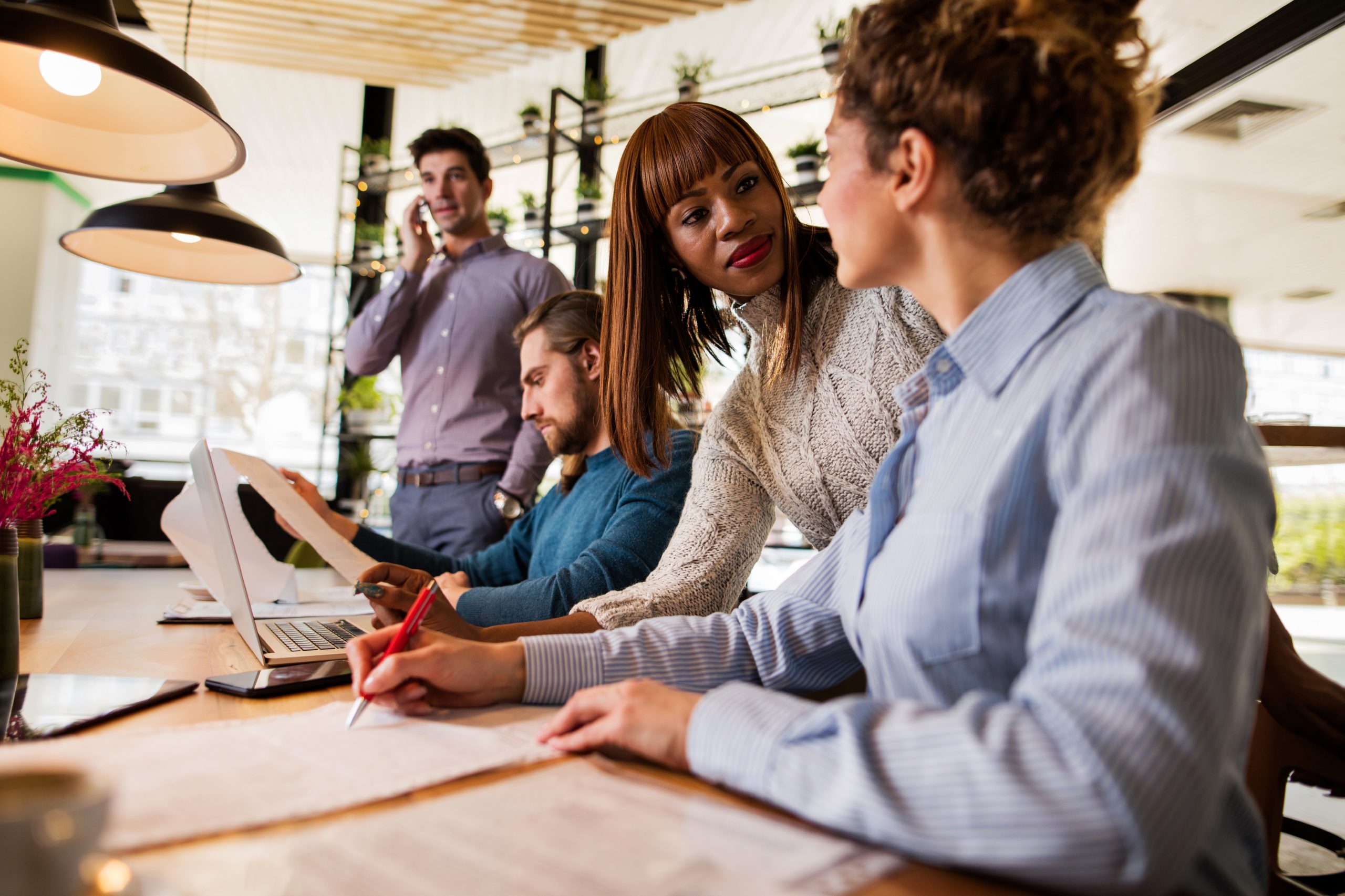 a group of people working together at a meeting table
